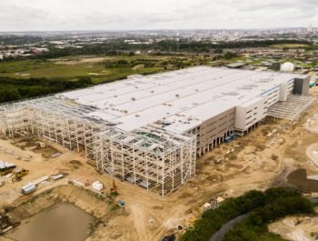 Aerial view of a large distribution centre warehouse on the outskirts of a large city being built and under construction