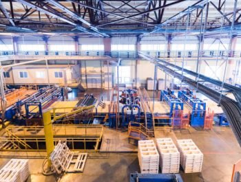 Factory workshop interior and machines on glass production background